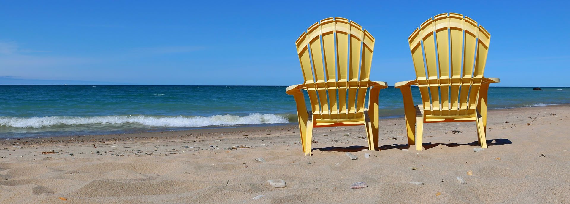 Plastic beach chairs on beach